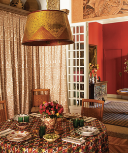 Dining room featuring various patterned textiles and orange shades